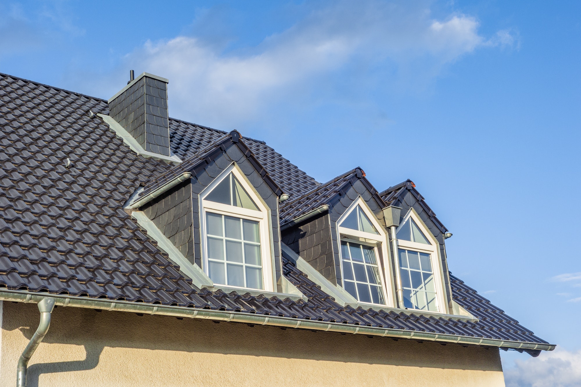 dormers-on-the-grey-slate-roof-with-the-sky-in-the-background.jpg